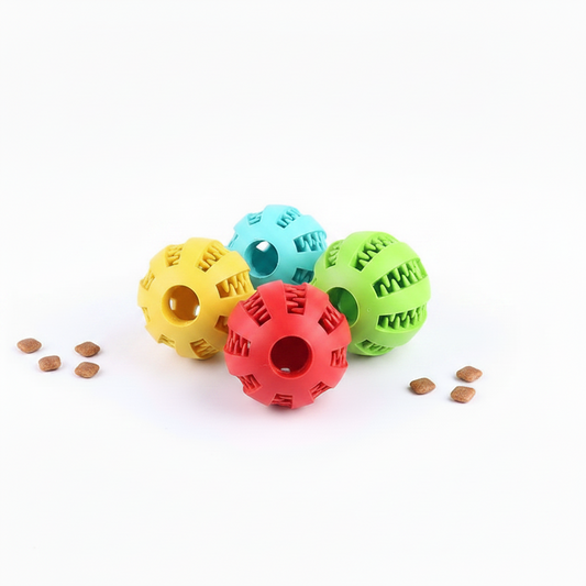 Rubber Treat Feeder colorful balls designed for pets with treats scattered around.